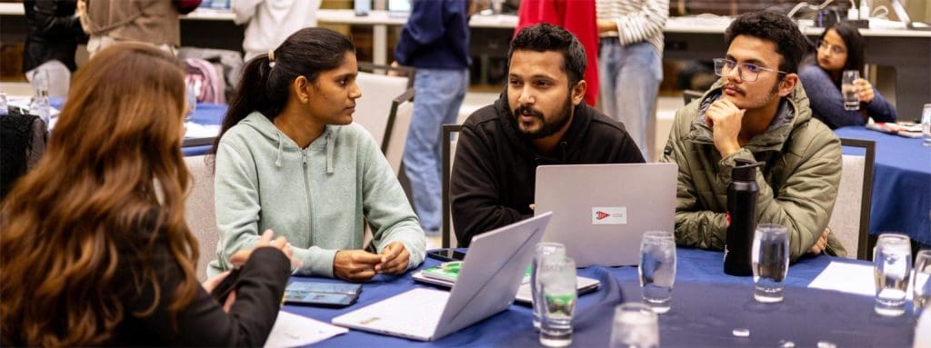 group sitting at laptops