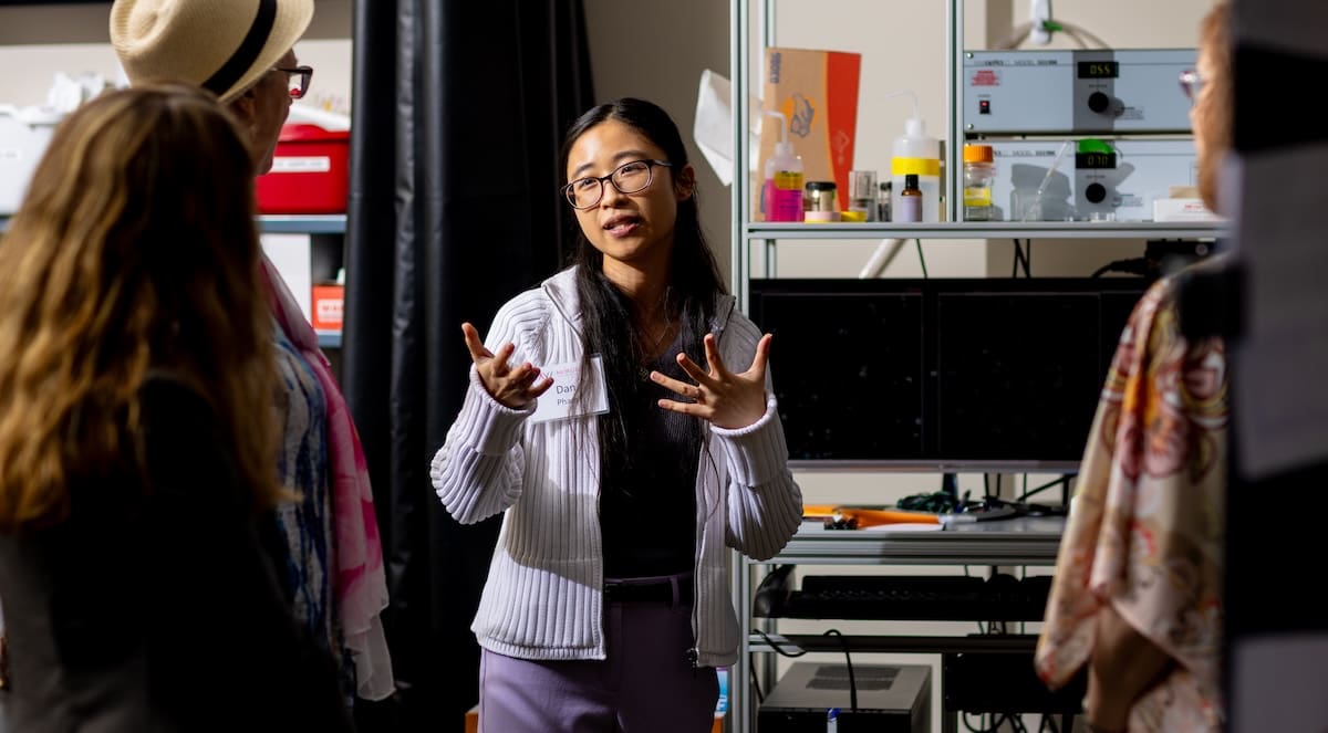 Dan Pham, a postdoc in the Skala Lab, explains her research on CAR T cells at a special event.
