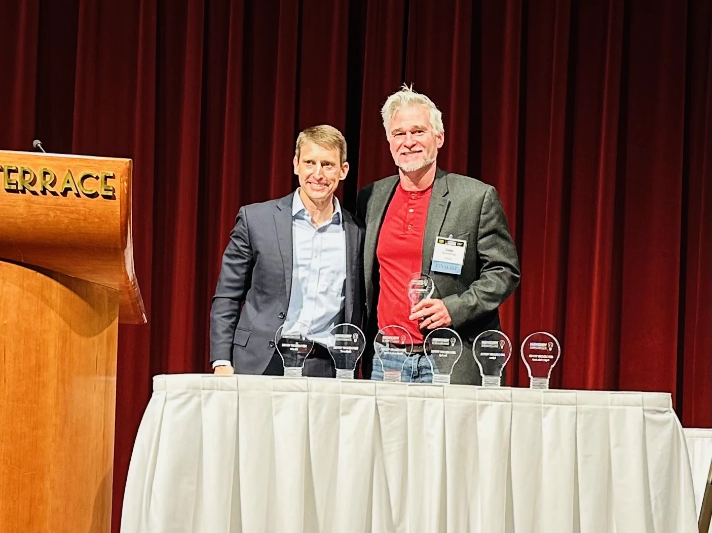 Matt Younkle presents the Biotech award to Luke Roenneburg, Associate Director Genomics & Instrumentation at Promega Corporation
