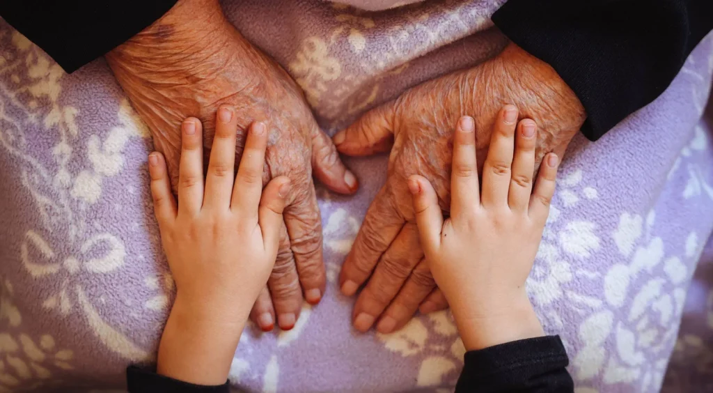 hands of elderly person and child